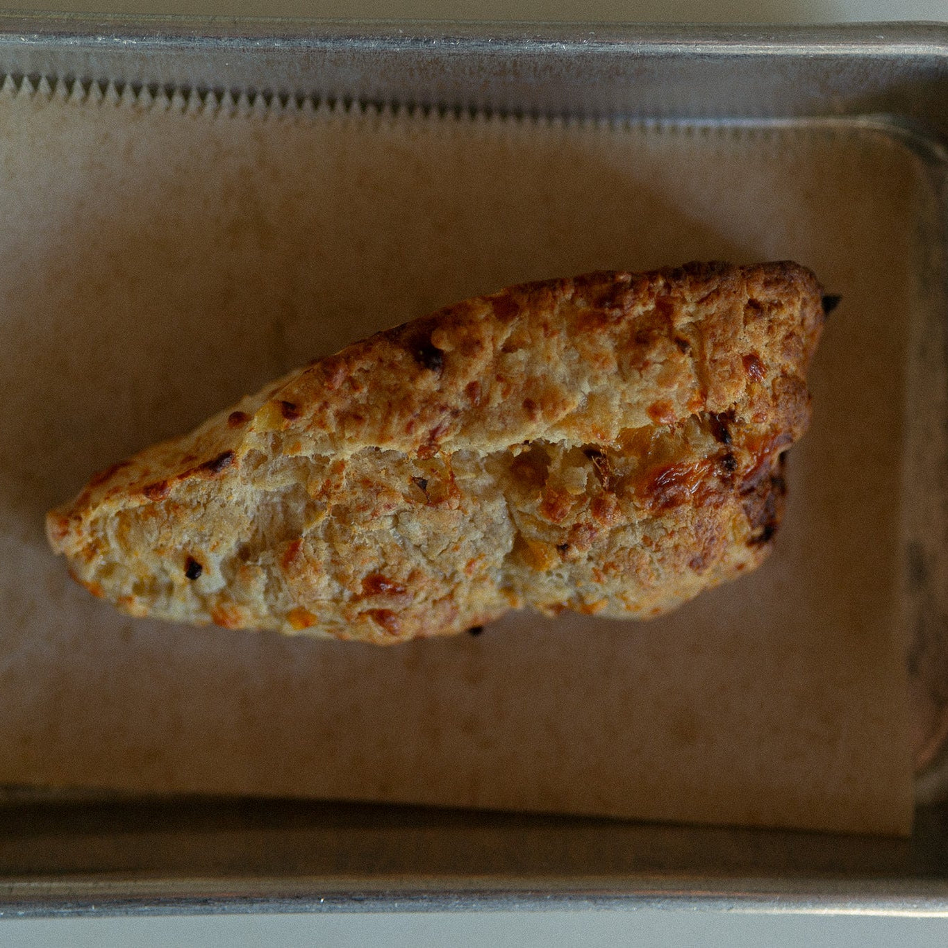 Baked good on a baking tray with brown paper