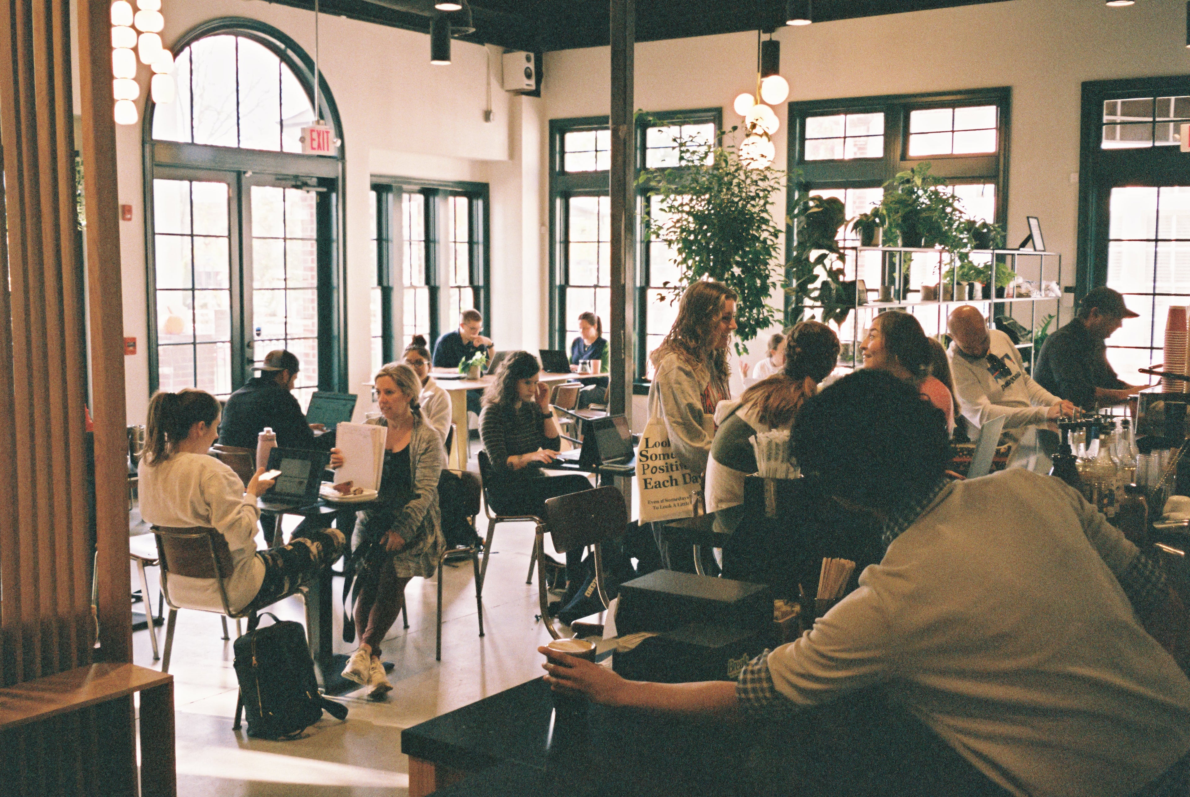busy cafe with large windows and ambient lighting