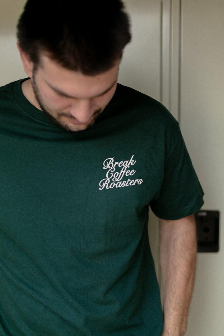 Man wearing a green t-shirt with 'Break Coffee Roasters' text.